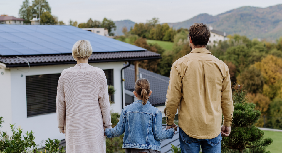 Couple in front of house with solar panels